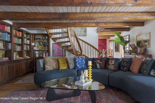 living room featuring beamed ceiling, wood-type flooring, and wood ceiling