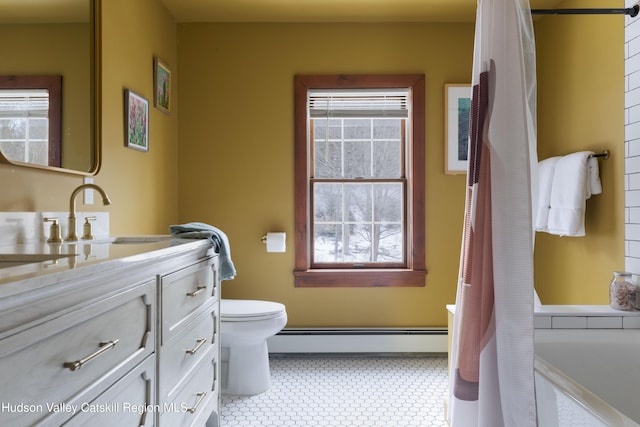 bathroom with vanity, toilet, and a baseboard heating unit