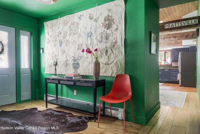 interior space featuring a baseboard radiator and light hardwood / wood-style flooring