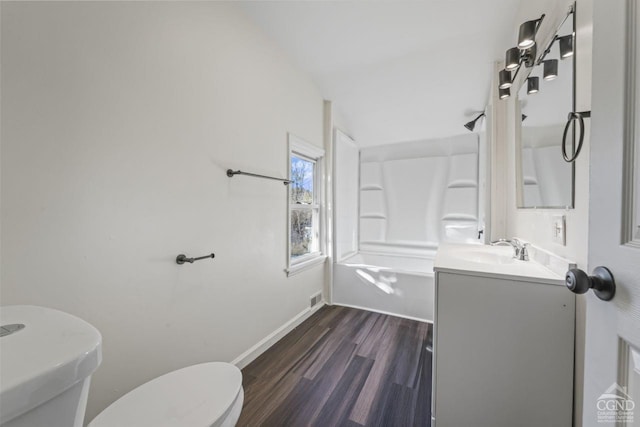 124 Cottage St, Ravena, NY 12143 - full bath featuring wood finished floors, toilet, vanity, shower / washtub combination, and baseboards