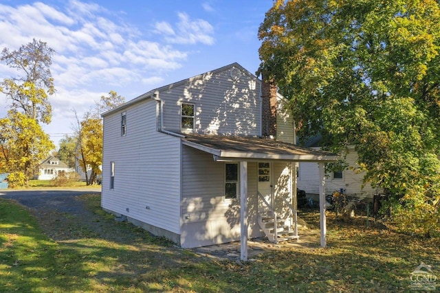 124 Cottage St, Ravena, NY 12143 - rear view of property featuring a chimney and a yard
