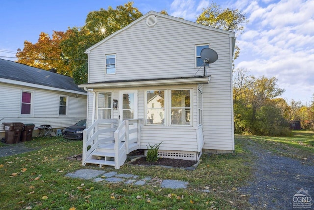 124 Cottage St, Ravena, NY 12143 - back of property with a lawn and a sunroom