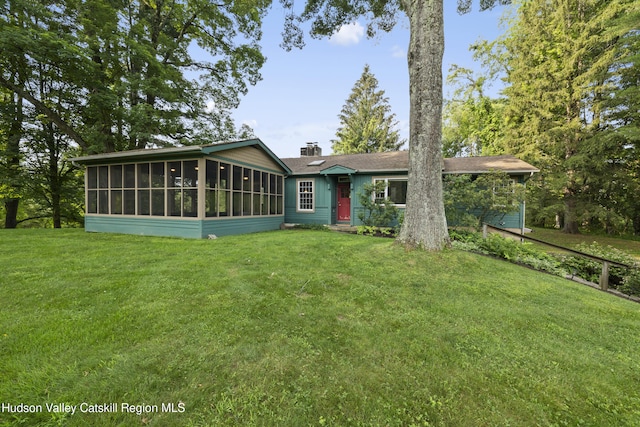 293 Pine Bush Rd, Stone Ridge, NY 12484 - rear view of property featuring a sunroom, a lawn, and a chimney