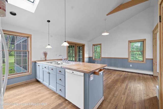 293 Pine Bush Rd, Stone Ridge, NY 12484 - kitchen with a peninsula, a skylight, dishwasher, light wood-style flooring, and a wainscoted wall