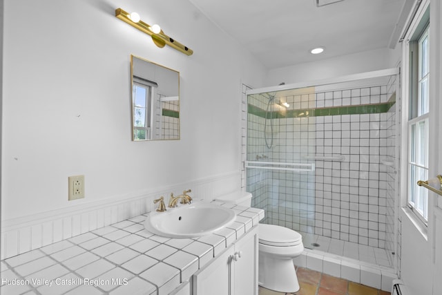 293 Pine Bush Rd, Stone Ridge, NY 12484 - full bathroom with vanity, a stall shower, plenty of natural light, and wainscoting