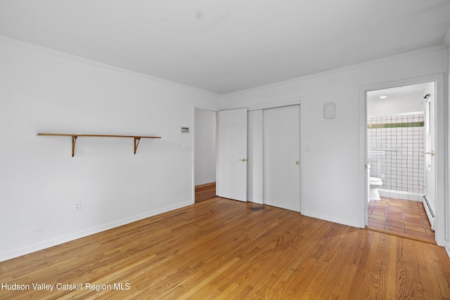 293 Pine Bush Rd, Stone Ridge, NY 12484 - unfurnished bedroom with light wood-style flooring, crown molding, ensuite bath, a baseboard heating unit, and a closet
