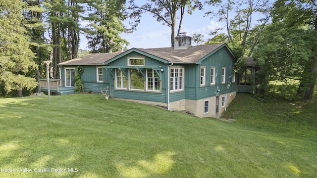 293 Pine Bush Rd, Stone Ridge, NY 12484 - rear view of property featuring a lawn, a shingled roof, a chimney, and a deck