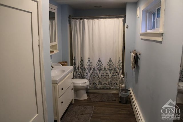 5948 Rte 81, Greenville, NY 12083 - bathroom featuring a baseboard radiator, toilet, wood finished floors, vanity, and shower / bath combo with shower curtain