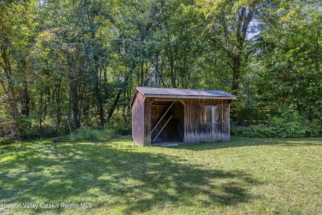 view of shed with a wooded view