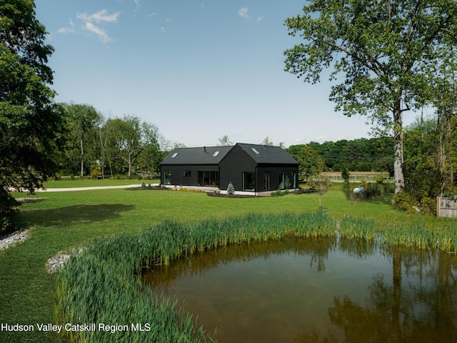 3 Schoolhouse Rd, Saugerties, NY 12477 - rear view of house featuring a lawn, a water view, and metal roof