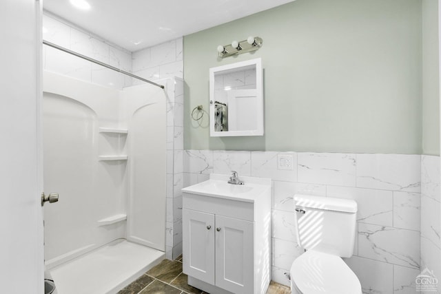 4 Lawrence Ave, Coxsackie, NY 12051 - full bath with tile walls, a shower stall, vanity, toilet, and a wainscoted wall