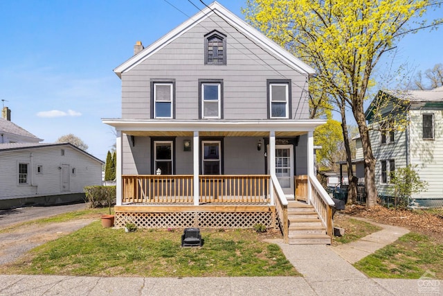 4 Lawrence Ave, Coxsackie, NY 12051 - american foursquare style home featuring a porch and a chimney