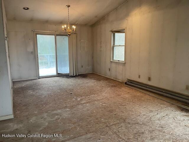 unfurnished room with a chandelier, a baseboard heating unit, and lofted ceiling