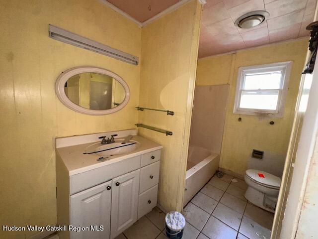 bathroom with toilet, tile patterned floors, and vanity