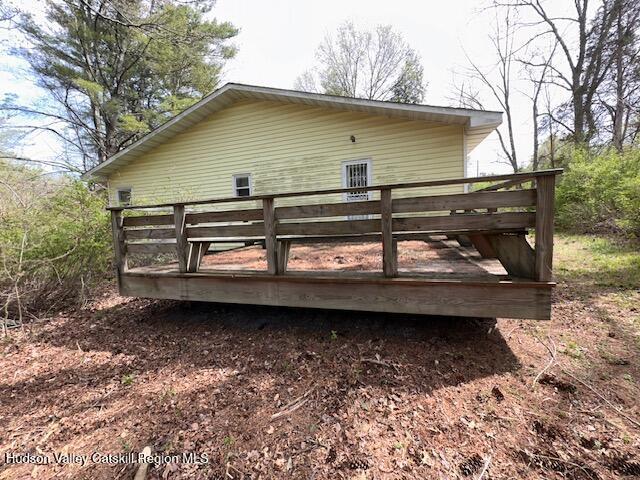 rear view of property featuring a deck
