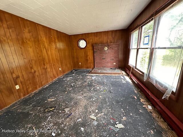 unfurnished room with wooden walls