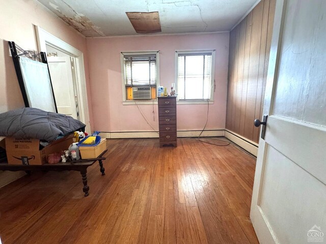 417 State St, Hudson, NY 12534 - unfurnished room featuring wood finished floors, cooling unit, baseboards, and baseboard heating