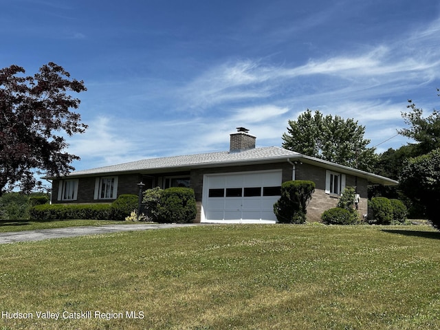 ranch-style house featuring a front yard and a garage