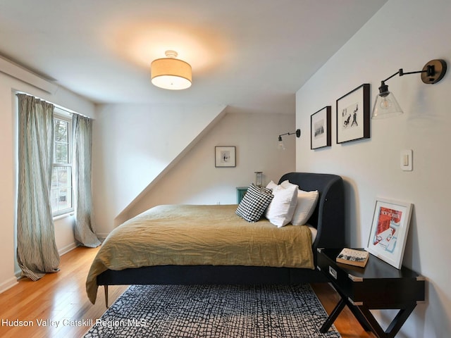 bedroom with hardwood / wood-style flooring