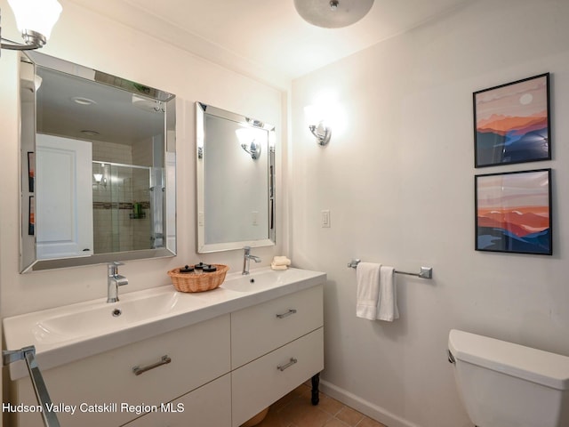 bathroom featuring vanity, toilet, a shower with shower door, and tile patterned flooring