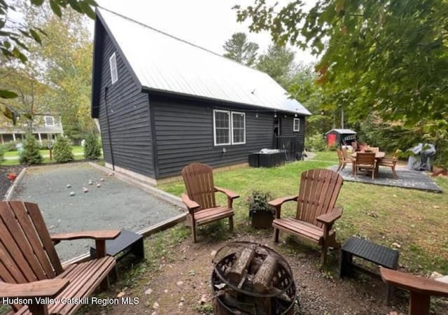 exterior space with a yard, a fire pit, and a patio