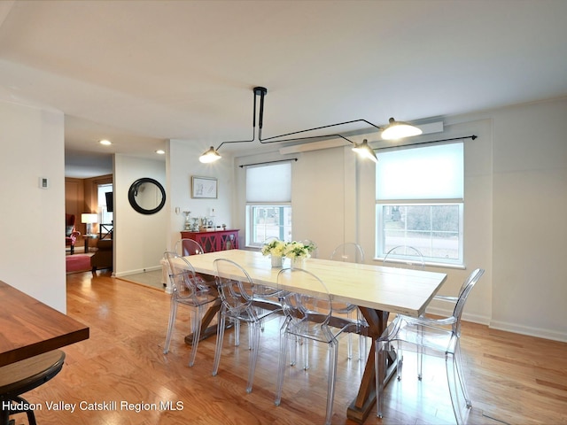 dining room with plenty of natural light and light wood-type flooring