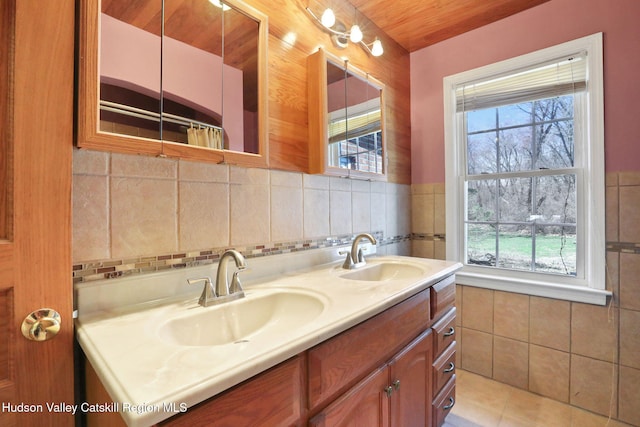 bathroom featuring tile walls, a wealth of natural light, and a sink