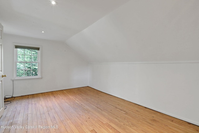 bonus room with lofted ceiling and hardwood / wood-style floors