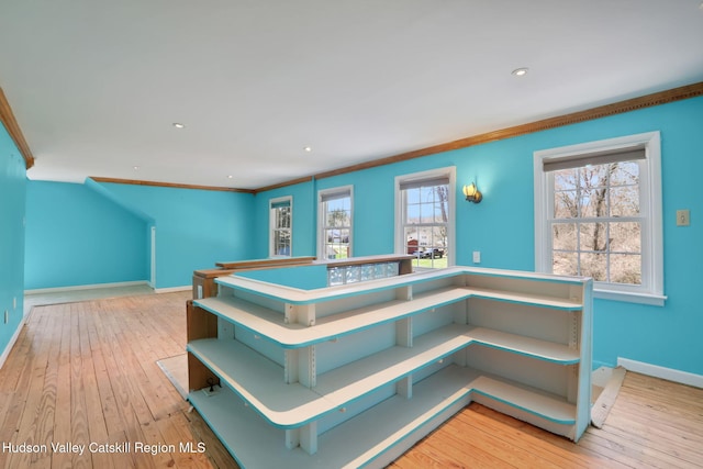 stairs with hardwood / wood-style flooring, baseboards, and crown molding