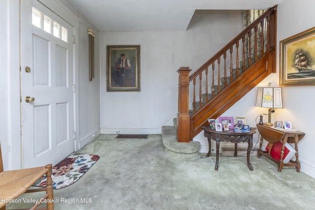 view of carpeted foyer entrance