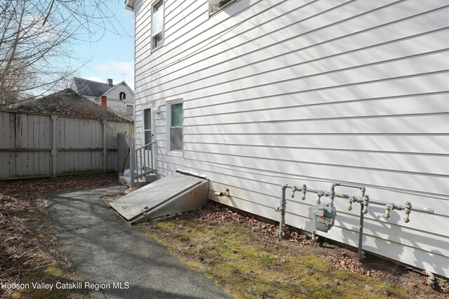 view of property exterior featuring fence