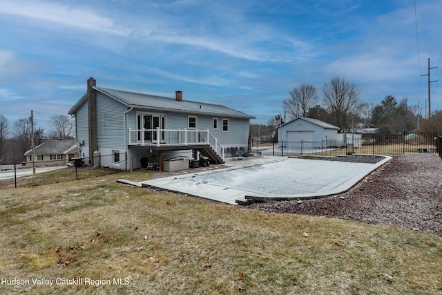 rear view of property with a lawn, a patio area, and a wooden deck