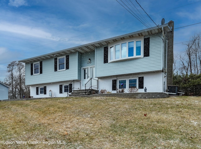 split foyer home with a front yard and central AC