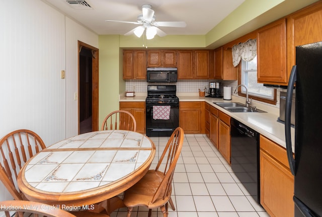 kitchen with tasteful backsplash, ceiling fan, sink, black appliances, and light tile patterned flooring