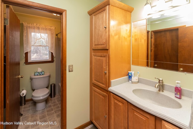 bathroom featuring vanity and toilet