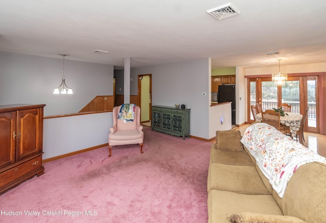 carpeted living room with wood walls, french doors, and a chandelier