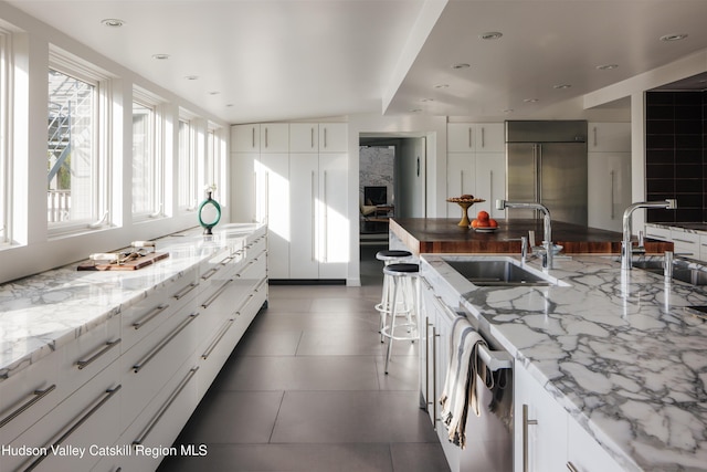 46 Pompeys Cave Rd, High Falls, NY 12440 - kitchen with a sink, appliances with stainless steel finishes, light stone countertops, white cabinets, and recessed lighting