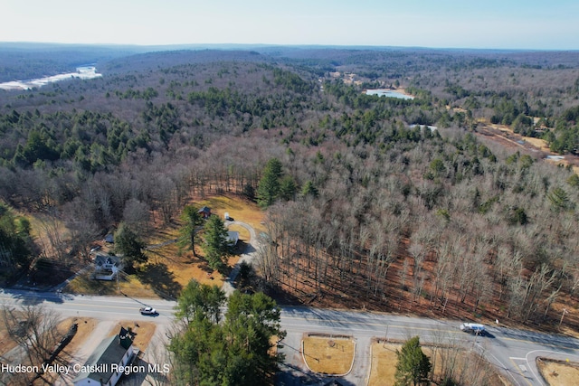 birds eye view of property with a wooded view