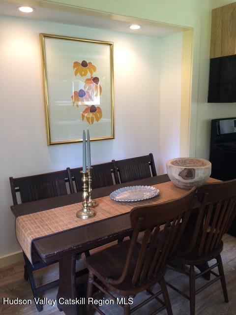 dining space featuring wood finished floors and recessed lighting