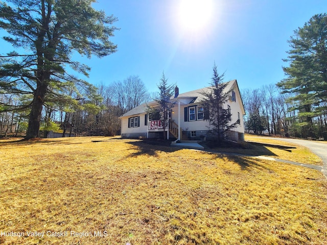 view of front of property featuring a front yard and a chimney