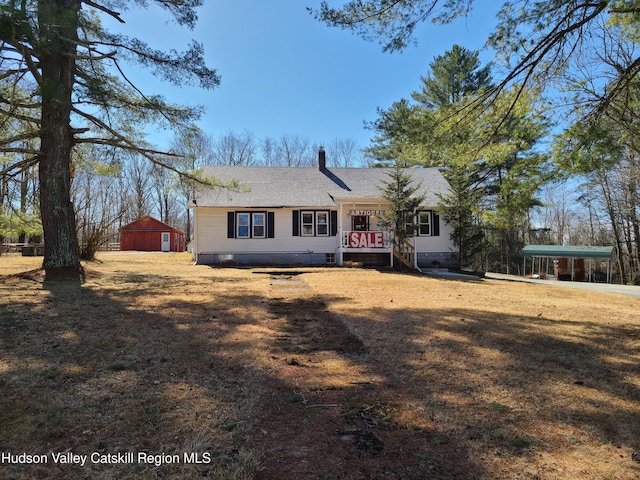 view of front of property with a chimney, crawl space, a front yard, roof with shingles, and a carport