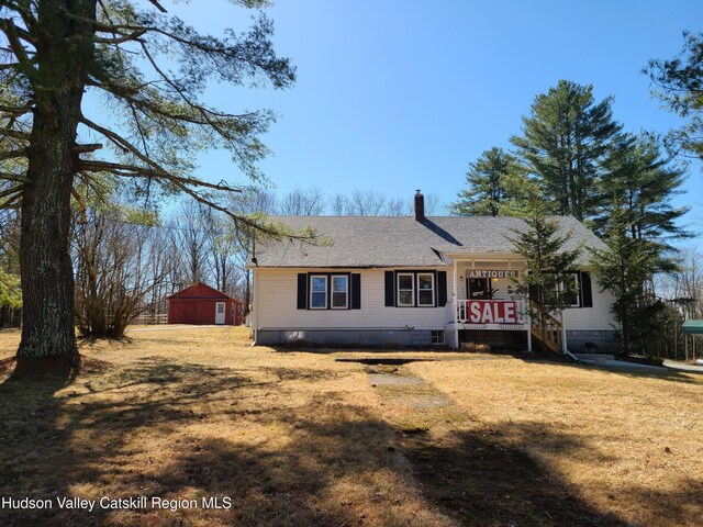 view of front of property with a shingled roof, crawl space, a chimney, and a front yard