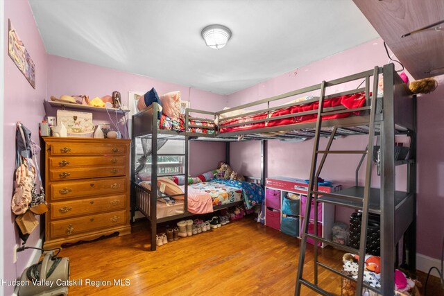 bedroom with wood finished floors