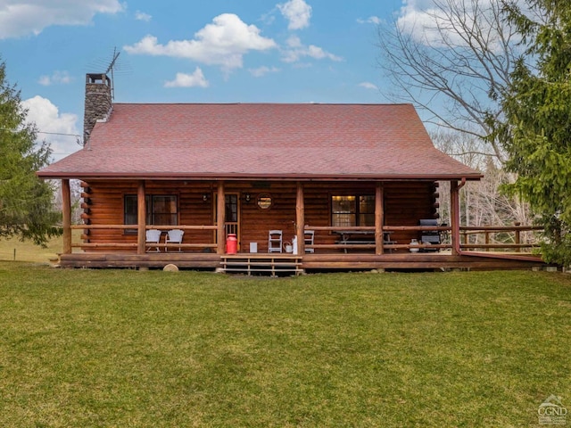 142 Pangman Rd, Gilboa, NY 12076 - view of front of home featuring log exterior, a chimney, and a front lawn