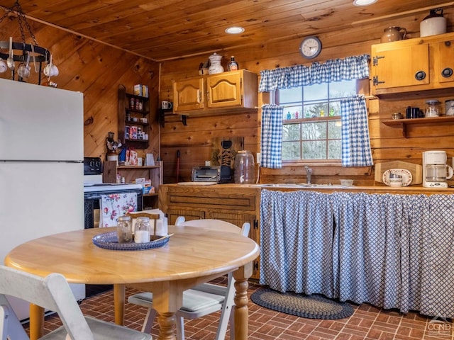 142 Pangman Rd, Gilboa, NY 12076 - kitchen with freestanding refrigerator, wood walls, brick patterned flooring, wooden ceiling, and a sink