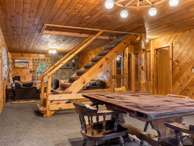142 Pangman Rd, Gilboa, NY 12076 - carpeted dining area featuring wood walls, wooden ceiling, and stairs