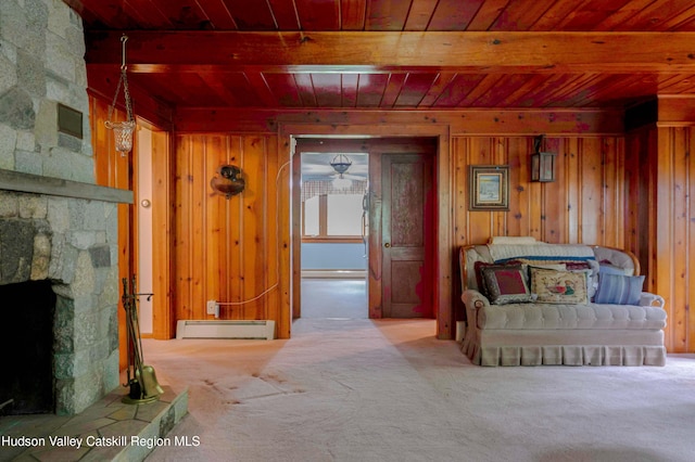 623 Rte 9j, Stuyvesant, NY 12173 - carpeted living room with wooden ceiling, a baseboard heating unit, a stone fireplace, wood walls, and a baseboard radiator