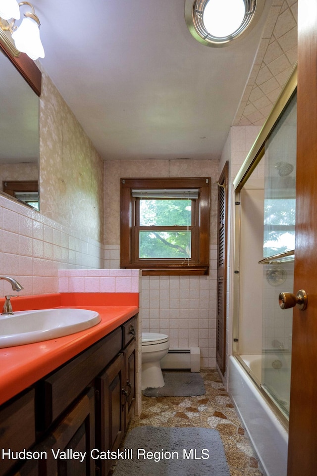 623 Rte 9j, Stuyvesant, NY 12173 - bathroom featuring tile walls, baseboard heating, vanity, and shower / bath combination with glass door