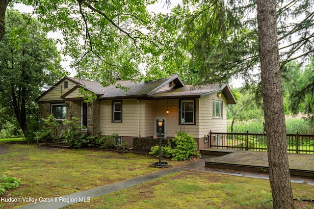 623 Rte 9j, Stuyvesant, NY 12173 - view of front of house featuring a front yard, stone siding, a deck, and roof with shingles