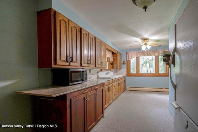623 Rte 9j, Stuyvesant, NY 12173 - kitchen featuring baseboard heating, ceiling fan, freestanding refrigerator, open shelves, and brown cabinets